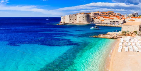Poster medieval Dubrovnik town - pearl of Adriatic coast in Croatia. Panoramic view with beautiful  sandy beach. © Freesurf