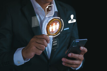 Businesspeople use a magnifying glass to find goals for their CRM business or customer relationship management and customer focused audience concepts. social media online digital marketing