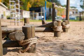 Wooden beams on the playground with sand. Equipment for Climbing or Playing.