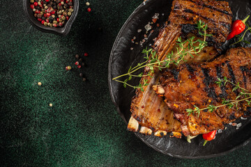 Grilled Lamb Chops on a dark background. top view. copy space for text