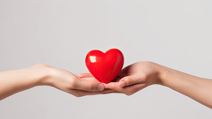 Fototapeta premium A man gives a woman a red heart on a white background