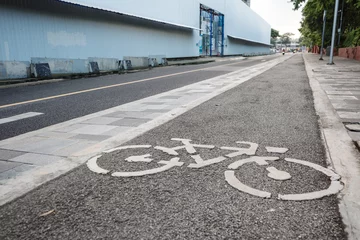 Deurstickers View of bicycle icon symbol on bicycle lane on the road of downtown in Bangkok, Thailand. Cycling friendly city in Thailand.  © Peeradontax