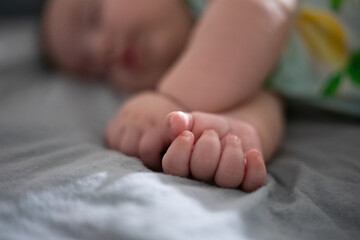 baby sleeping peacefully with selective focus on hand