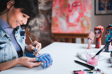 Young artist painting in art class at school studio. Creative people doing craft work