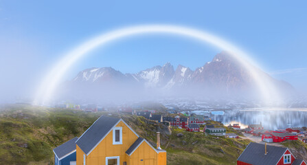 Picturesque village on coast with white rainbow - Greenland - Colorful houses in Tasiilaq, East Greenland
