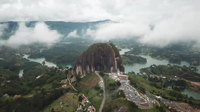 Aerial drone footage of El Penon de Guatape near Medellin in Antioquia, Colombia. Large and unique alone rock with stairs to the top, touristic place. Big stone in Colombia. High quality 4k footage.