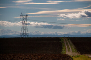 Isolated high voltage electrical tower on a crop field