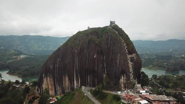 Aerial drone footage of El Penon de Guatape near Medellin in Antioquia, Colombia. Large and unique alone rock with stairs to the top, touristic place. Big stone in Colombia. High quality 4k footage.
