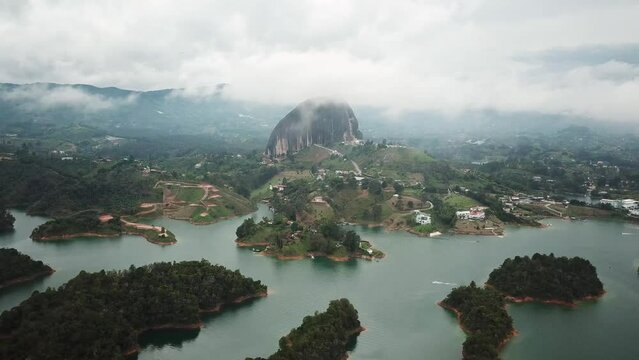 Aerial drone footage of El Penon de Guatape near Medellin in Antioquia, Colombia. Large and unique alone rock with stairs to the top, touristic place. Big stone in Colombia. High quality 4k footage.