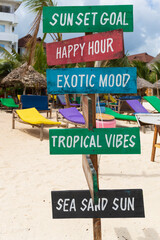 Colorful signs with the writing sun set goal,Happy hour,exotic mood,tropical vibes,sea sand sun, on...