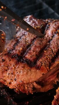 cooking steaks on the fire in real Close-up view of juicy cooked slices of meat with flames. original dish recipe. Professional cooking, food recipe, cooking. Horizontal . Top view.