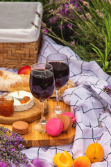 A woman drinks wine in a lavender field. Selective focus.