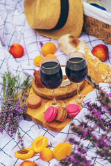A woman drinks wine in a lavender field. Selective focus.