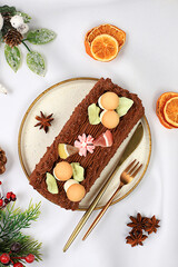 Homemade winter dessert, stollen or strudel with sweet cream filling, nuts, cinnamon and poppy seeds. Concept for holiday bakery, seasonal treats and cafe advertising,