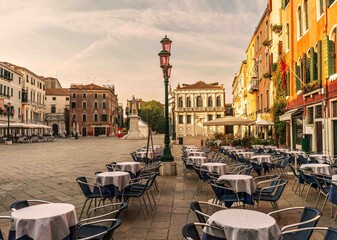 Campo santo stefano typical place in venice italy architecture with restaurant tables out