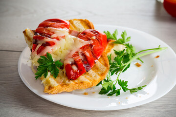 hot sandwich of fried toast bread with baked peppers and cheese