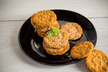 cooked sweet oatmeal cookies on wooden table