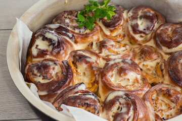prepared baked sweet Cinnabon with cream in a baking dish .