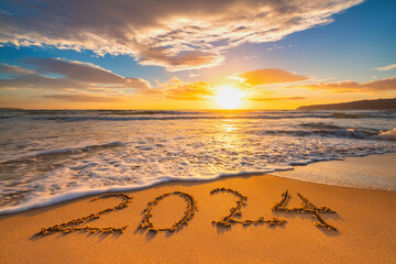 Sea sunrise of first new day for 2024 year text on beach sand - obrazy, fototapety, plakaty