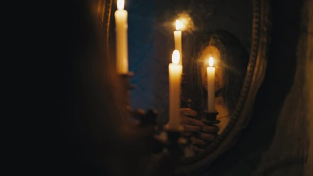 Old woman witch performing occult ritual using mirror, contacting evil spirits