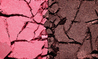 Pink and brown eyeshadow texture background. Cosmetic product crumbled swatch