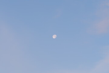 the moon in the sky during the day