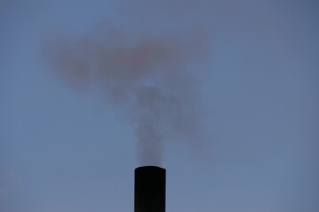 smoke comes from a black chimney