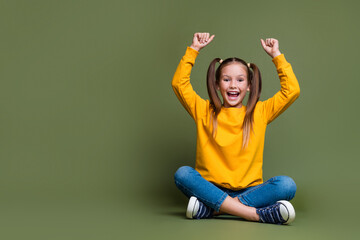 Full size photo of excited girl with ponytails wear yellow pullover raising hands up back to school...