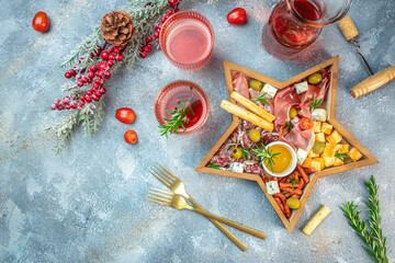 Christmas star board. Mixed cheese and meat with rose wine antipasto, Christmas holidays, place for text, top view