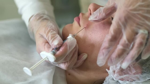A doctor injects filler into nasolabial folds, focus on precision. Image reflects the quest for youth and beauty in modern society.