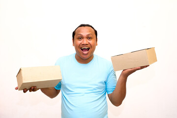 Happy young Asian man holding package parcel boxs isolated on white screen background. Delivery...