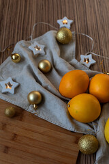 New Year's layout of oranges, board, napkins, garlands and balloons on the kitchen table.Preparations for the holiday.Preparing for the celebration of Christmas.The concept of a cozy kitchen