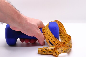 Close-up of dumbbells and measuring tape for physical - obrazy, fototapety, plakaty