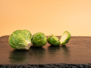 Brussels sprouts on a black slate stone. Fresh, small Brussels sprouts.
