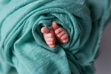 twisted child. Soft feet of a newborn