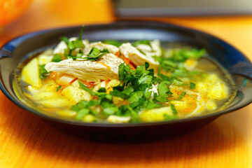 Soup with chicken, potatoes and herbs