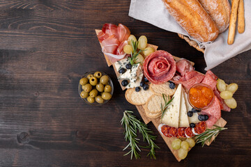 Charcuterie board italian food antipasti prosciutto ham, salami and cheese appetizers served in the shape of a Christmas tree.  party food for New Year's Eve and Christmas