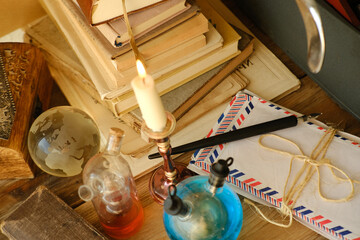 candle burning in candlestick, stack old books, letters, vintage typewriter, creative process and...