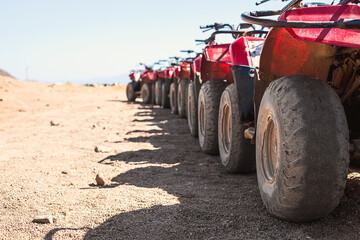 Red quads stand in a row on the shore of the Red Sea. Dahab, Egypt. © Natallia