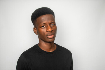 Young African gen Z isolated on white background looks defensive 