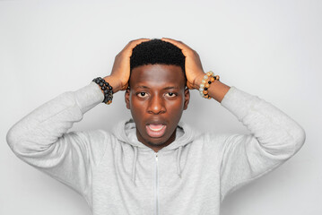 Happy cheerful young African gen Z isolated on white background. Funny confused state of mind in shock of news