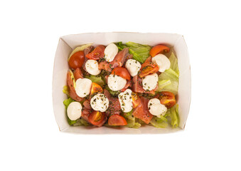 Delicious salad with trout and vegetables in a lunchbox on a white background. Isolated.