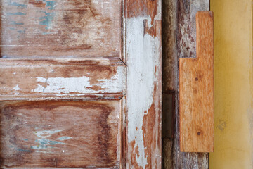 Vintage Charm: Weathered Wooden Door with Peeling Paint and Rustic Textures. 