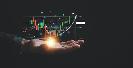 Navigating the complexities of the stock market, a trader or investor relies on a palm-sized device, examining candlestick charts and employing cutting-edge tools to optimize their trading strategies. - obrazy, fototapety, plakaty