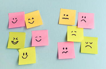 Many sticky notes with different emotions on blue background . Empathy Concept  