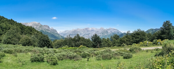 Fototapeta na wymiar Panoramic view at the Picos de Europa, or Peaks of Europe, a mountain range extending for about 20 km, forming part of the Cantabrian Mountains in northern Spain