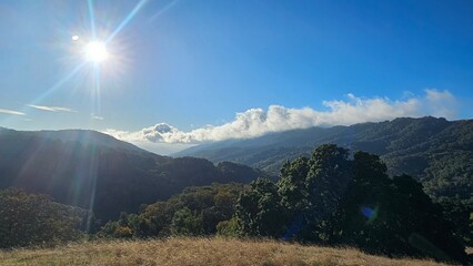 sun shining through the mountains