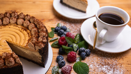 close-up of cheesecake with cream filling, decorated with fresh berries, blueberries and raspberries, festive New Year's cake, Christmas	