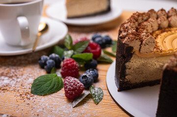 close-up of cheesecake with cream filling, decorated with fresh berries, blueberries and raspberries, festive New Year's cake, Christmas	