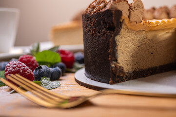 close-up of cheesecake with cream filling, decorated with fresh berries, blueberries and raspberries, festive New Year's cake, Christmas	